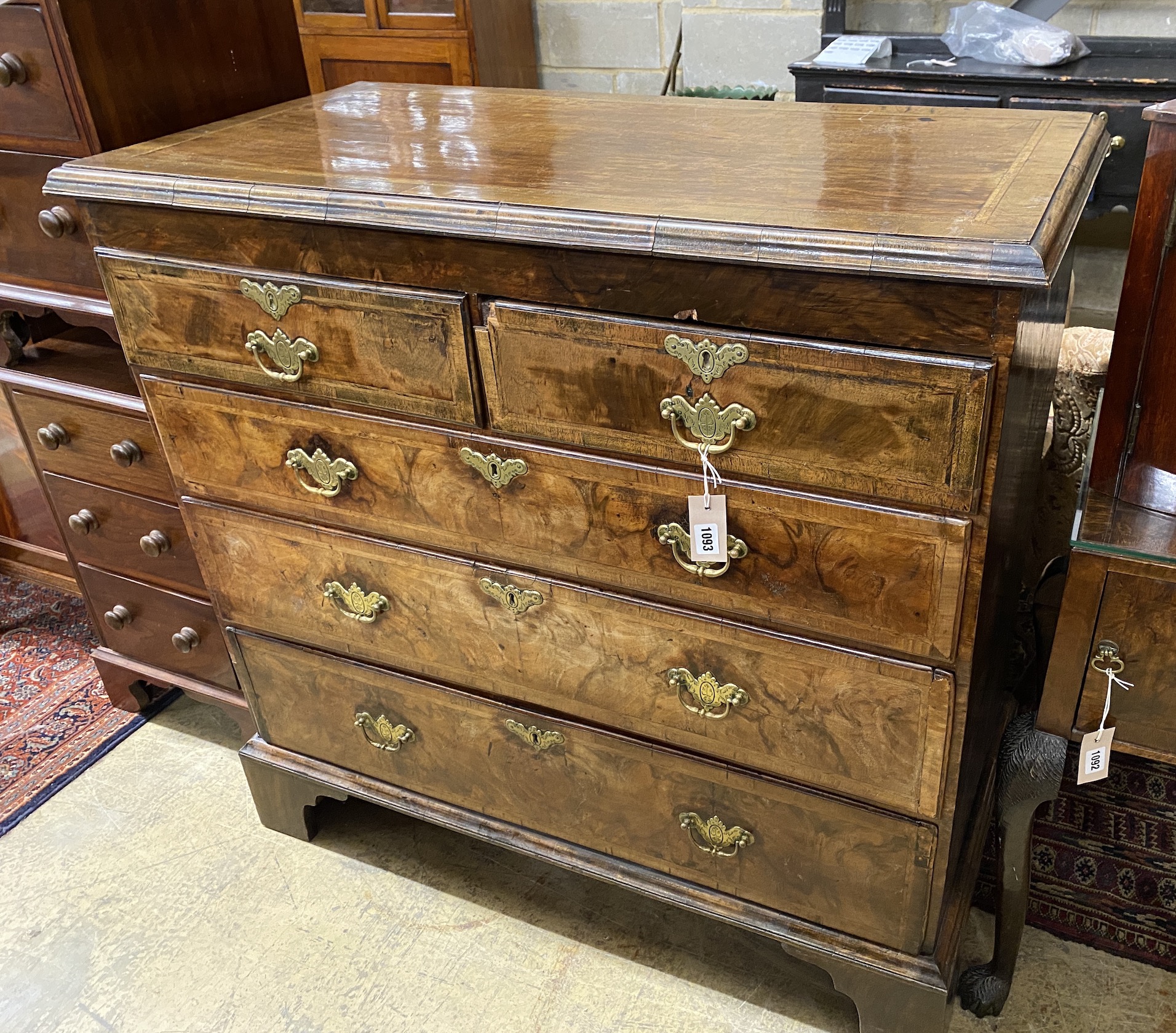 An 18th century feather banded walnut chest of drawers, width 104cm, depth 53cm, height 100cm